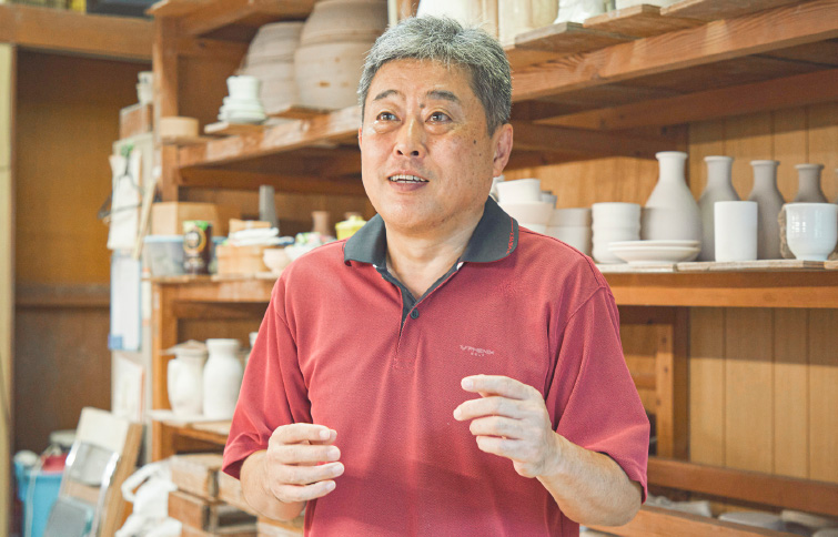 05 前日に窯入れをしたため、外気温よりかなり高い状態になった工房内で出石焼の歴史を語る山本さん。